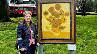 Photo of Rachel Gadsden next to a Van Gogh painting.