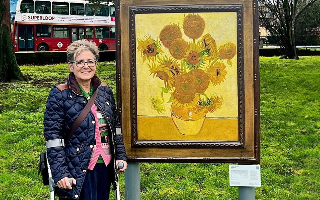 Photo of Rachel Gadsden next to a Van Gogh painting.