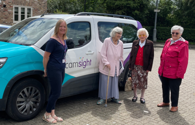 CamSight vehicle with four women in front smiling. 