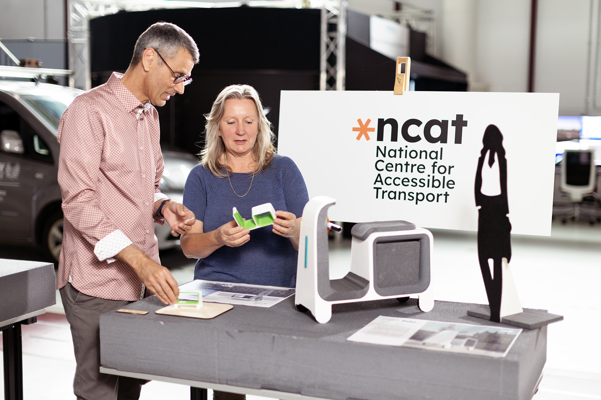 A man and woman looking at a research model